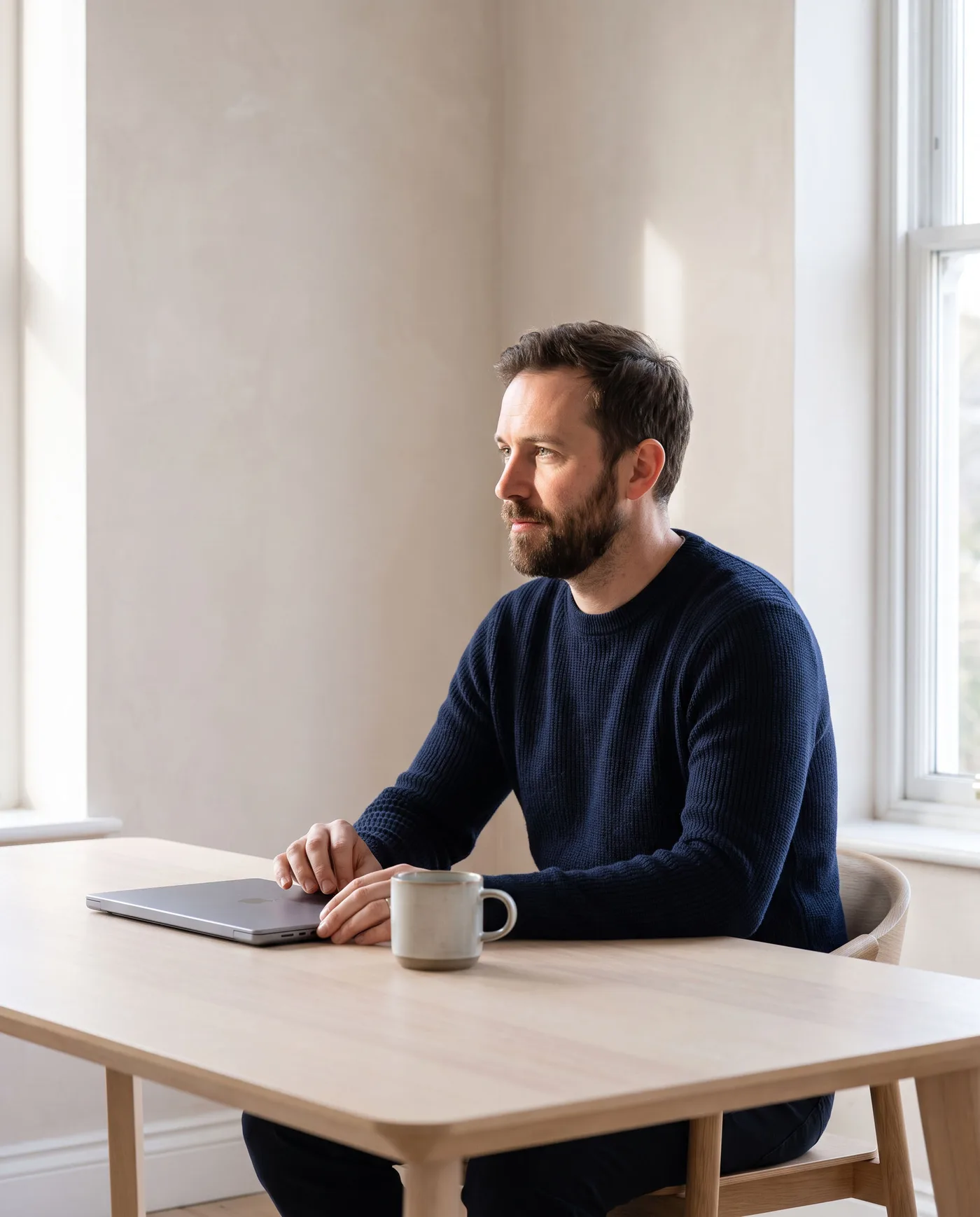 A bookkeeper working calmly at a modern desk in a bright home office