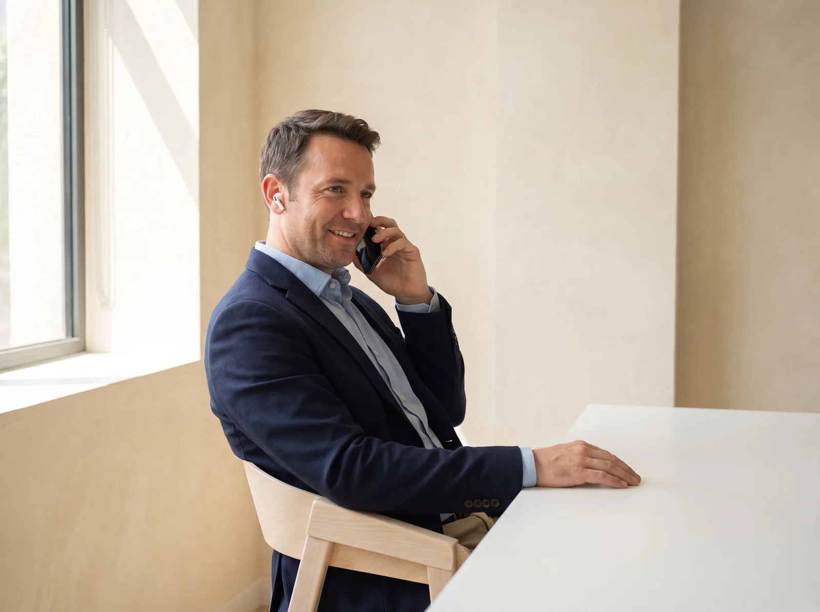A bookkeeper smiling during a phone call with a client
